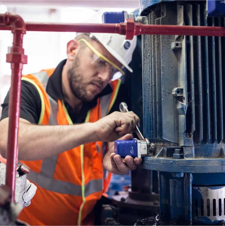 A man operating a machine in a factory.
