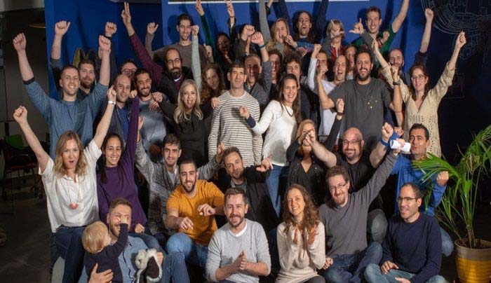 Group picture of Augury's reliability success team cheering.