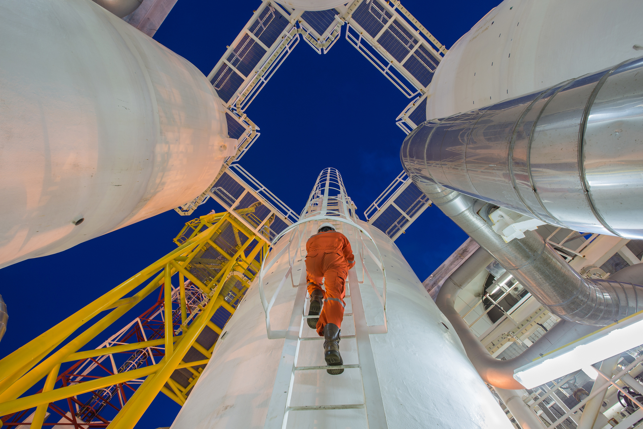 A man is climbing up a ladder to reach the top.