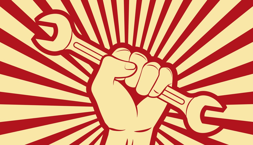Fist holding up wrench in victory