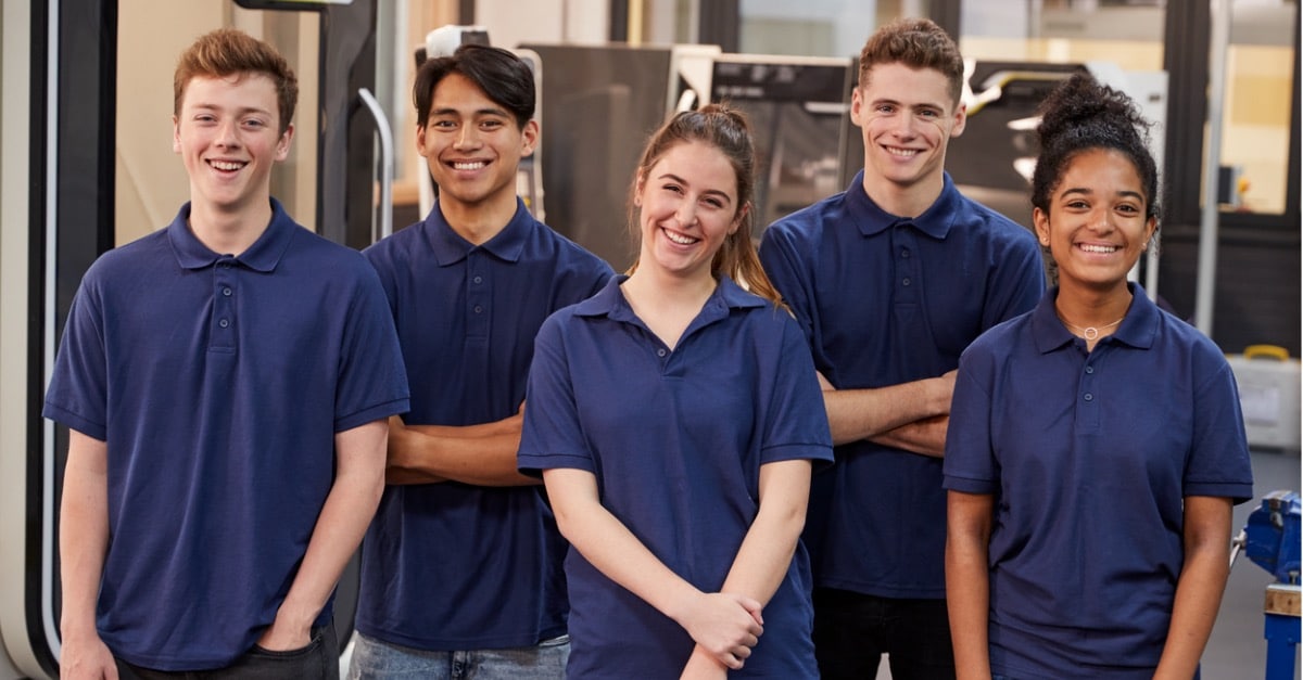 Young engineering students at a factory.